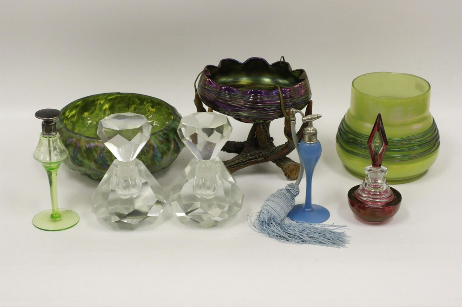 8pc Glass Lot includes Loetz style: 8pc Glass Lot, Including 3 Loetz Style Bowls & 5 Perfumes. Provenance from a Garden City, NY Collector. All in generally good condition. Some chips. Minor thread loss. All need cleaning. Dimensions of