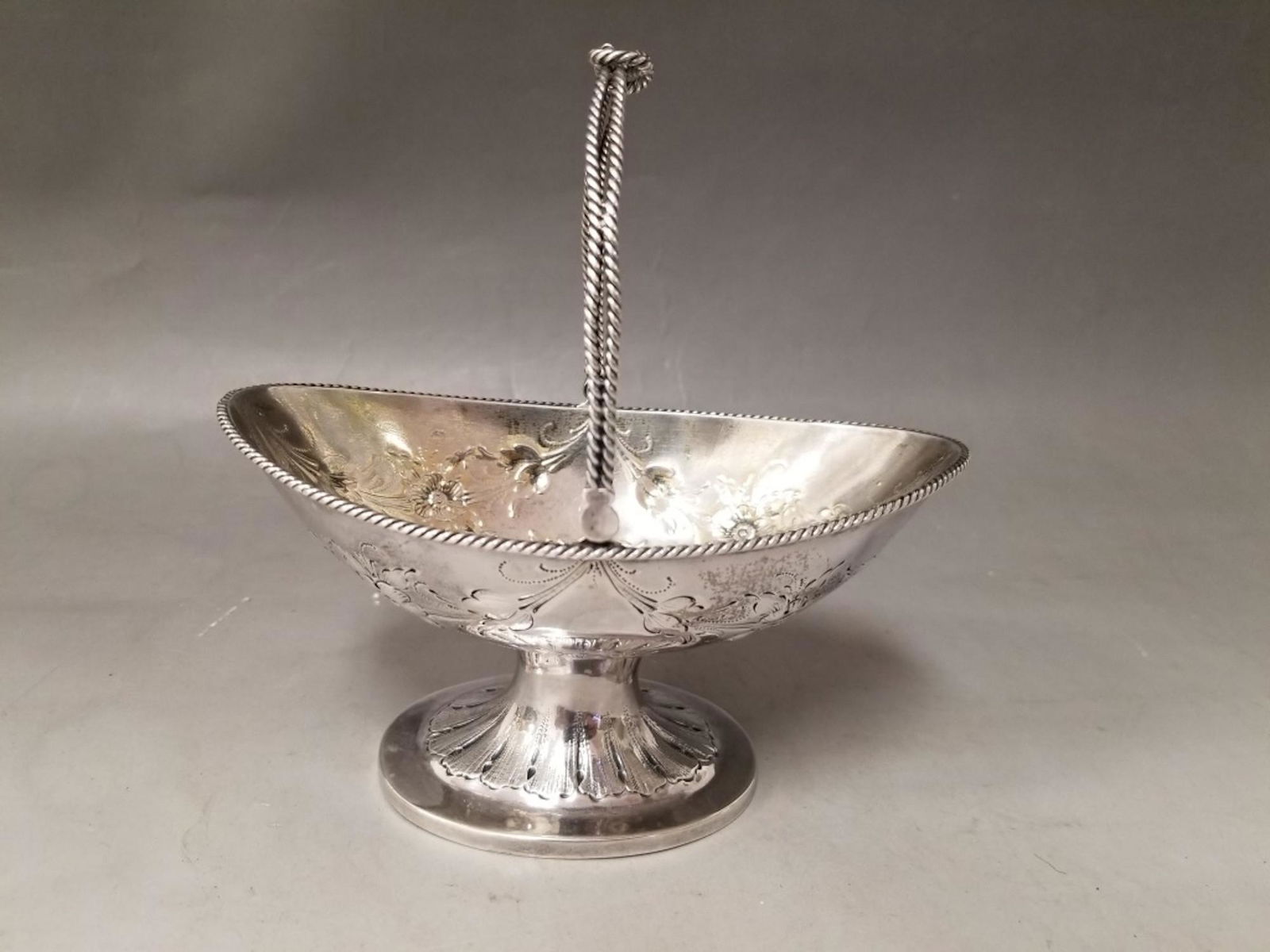 Southern Coin Silver Basket by John Ewan: Southern Coin Silver Basket by John Ewan. Charleston,SC. Circa 1840. Fully Hallmarked. Good Condition. Provenance From a Long Island, NY Collection. Total Weight- 137.6g/4.4ozt. Dimensions- Total H-6"