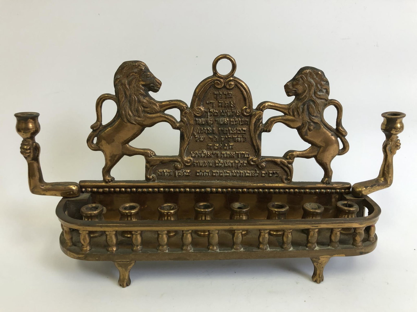 Judaica Early Bronze Menorah Hanukkah Lamp: Judaica Early Bronze Menorah Hanukkah Lamp w/ Lions & Shield. Possibly Polish or Hungarian. Can Be Used Hanging or Standing. Provenance From a New York Home. Good Condition. Dimensions- L-12" x H-6.25