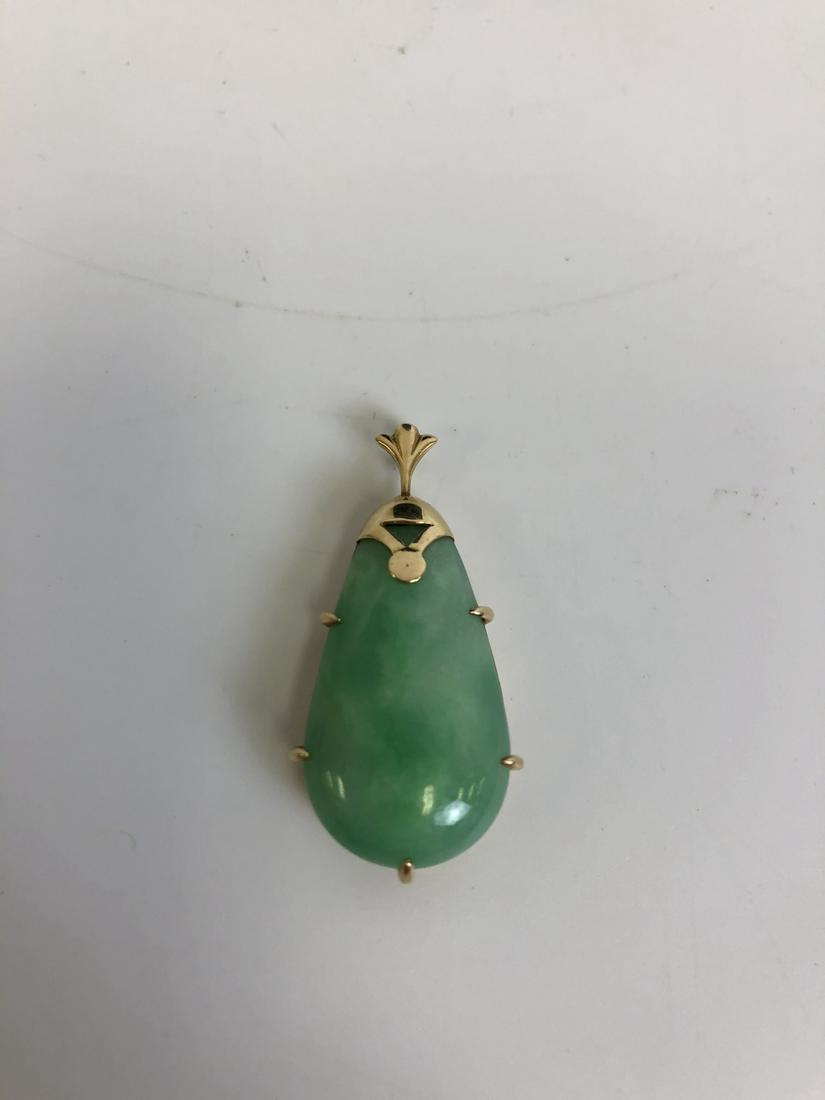 Unusual Chinese 14K Gold & Jade or Jadeite Pendant: Unusual Chinese 14K Gold & Jade or Jadeite Pendant. Provenance from a New York Home. Good Condition. Dimensions- L-1.25". Weight- 7.5g/.24dwt. Please note the absence of a condition report does not im