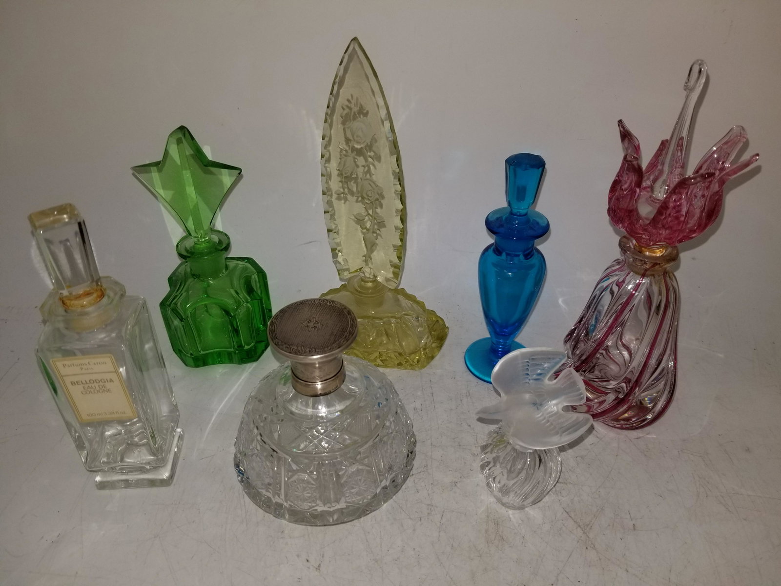 A large lot of 36 Vintage glass Perfume bottles: A large lot of 36 Vintage glass Perfume bottles, including One Lalique example, a few Czech examples, etc. Provenance: From a Long Island Home. Please note the absence of a condition report does not i