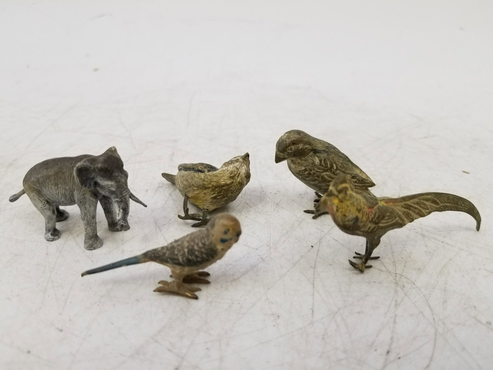 5 Miniature Austrian Cold painted Bronze Figures: 5 Miniature Austrian Cold painted Bronze Figures of birds and Elephant. Generally good condition, one bird does not stand. Dimensions: Tallest H 1.25" Provenance: From a Long Island Estate. Please not