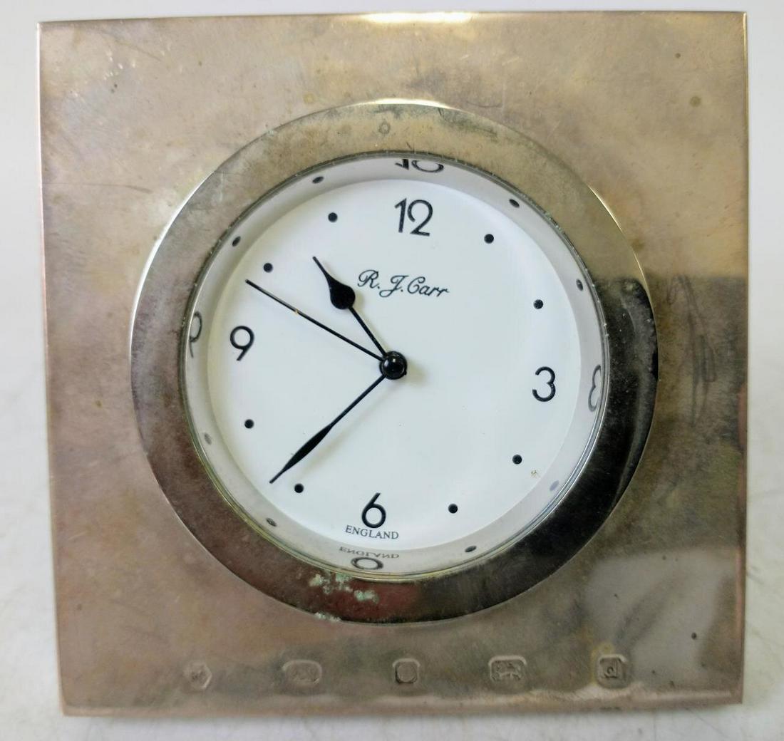 English Sterling Silver Easel Desk Clock: English Sterling Silver Hallmarked Easel Shaped Desk Clock w/ Wood Backing by R. J. Carr. Condition: Generally Good Condition. Dimensions: 4" Square. Provenance: From a Queens, NY Home.Please note the