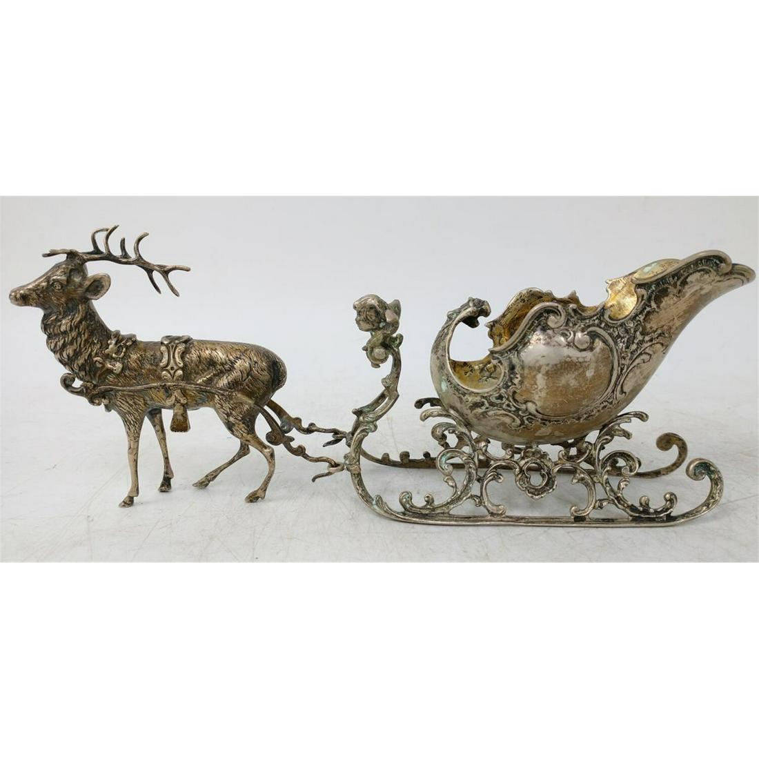 Early Continental Silver 2 Piece Set Deer & Sled: Early Continental Silver 2 Piece Set Deer Pulling Sled w/ Cupid. Condition: Generally Good Condition.Total Weight: 348g/11.19oztDimensions: Total L-11" x Total H-4".Provenance: From a Queens, NY Home.