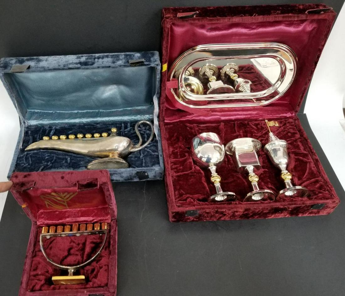 Judaica Lot of 2 Silvered Metal Hanukkah Menorahs: Judaica Lot of 2 Silvered Metal Hanukkah Menorahs & 1 Other. All in Original Boxes.Condition: All in Generally Good Condition.Provenance: From a Long Island, NY Home.Please note the absence of a condi