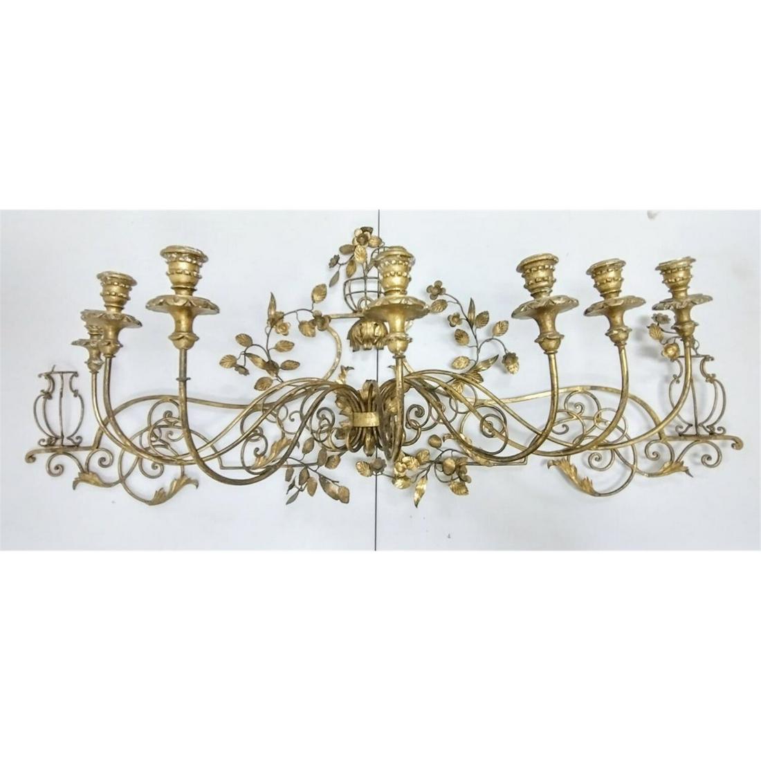 Very Large Highly Decorative Brass Wall Sconce: Very Large Highly Decorative 7 Light Brass Wall Sconce, with Carved Wood Gold Gilded Candle Holders. Condition: Generally Good. Has one small flower decoration missing.Dimensions: L- 55" x H-21".Prove