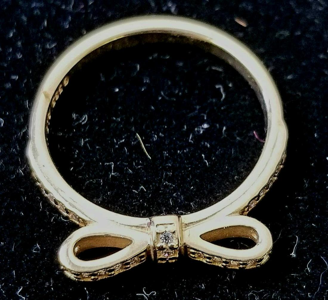Pandora 14K Yellow Gold Bow Ring with Stones.: Pandora 14K Yellow Gold Bow Ring with Stones. Condition: Very Good.Dimensions: Ring Size- 7.5.Weight: 3g/1.9dwt.Provenance: From a Long Island, NY Estate.Please note the absence of a condition report