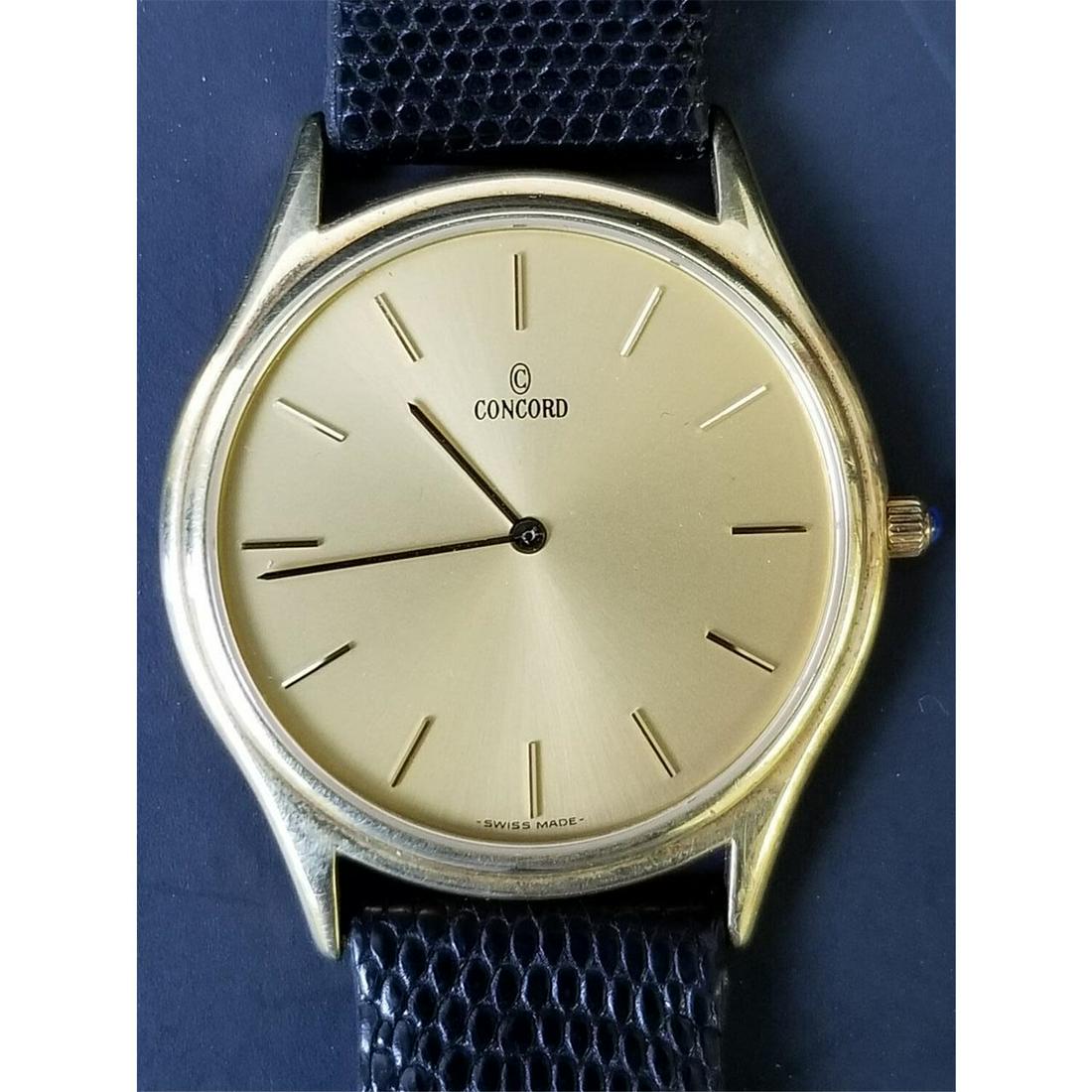 Concord Vintage 14K Gold Men's Watch: Concord Vintage 14K Gold Men's Watch w/ Leather Band in Original Box.Condition: Appears to be in Good Condition.Dimensions: Face- Dia- 1.45" Including Crown.Provenance: From a Long Island, NY Collecto