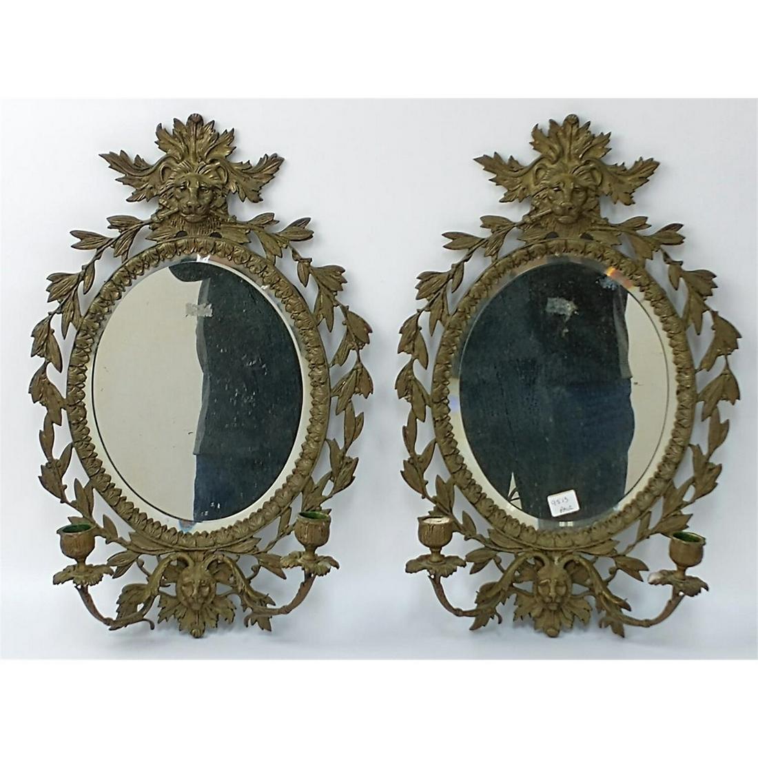 Pair of Antique Bronze Figural Mirror Sconces.: Pair of Antique Bronze Figural Mirror Sconces w/ Lion Head Motif. Condition: Generally Good Condition. Dimensions: W-11" x H-17".Provenance: From a Queens, New York Home. Please note the absence of a 