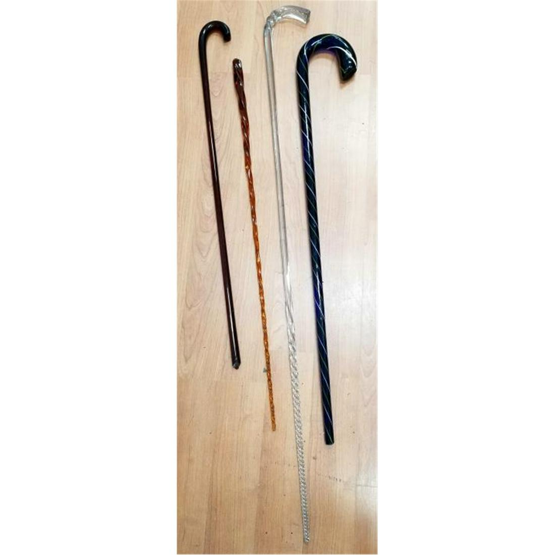Lot of 4 Old Glass Canes.: Lot of 4 Old Glass Canes. 2 Are Amber Color, 1 Clear & 1 Blue w/ Green & White Decoration. Condition: Bottom of all Are Broken. Dimensions: Longest- L-46". Provenance: From a Long Island, NY Collector