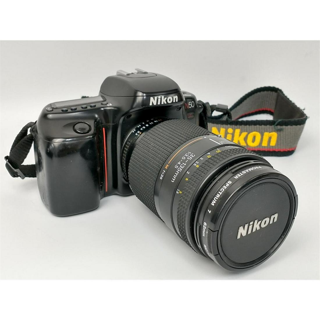 Nikon N50 Camera w/ Pro Master Spectrum 7 Lens.: Nikon N50 Camera with Pro Master Spectrum 7 Lens. All Made in Japan. Condition: Appears to be in Generally Good Condition. Provenance: From a Long Island, NY Home. Please note the absence of a conditi