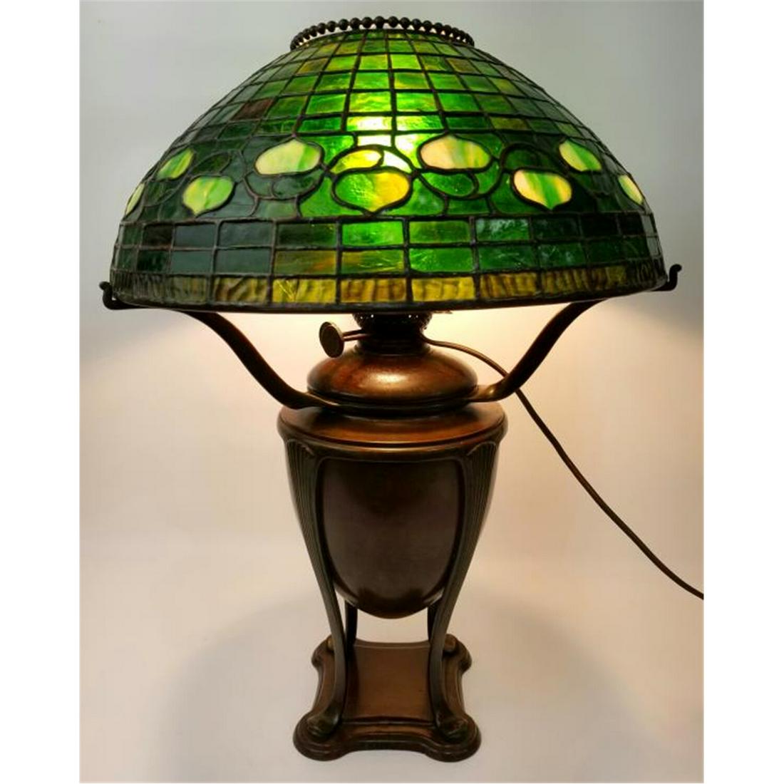 Tiffany Studios Table Lamp w/ Acorn Leaded Glass.: Tiffany Studios Early Table Lamp w/ Acorn Pattern Leaded Glass Shade & Urn Base. Both Base & Shade Are Signed. Condition: Appears to be in Generally Very Good Condition. Dimensions: Dia of Shade-16" x