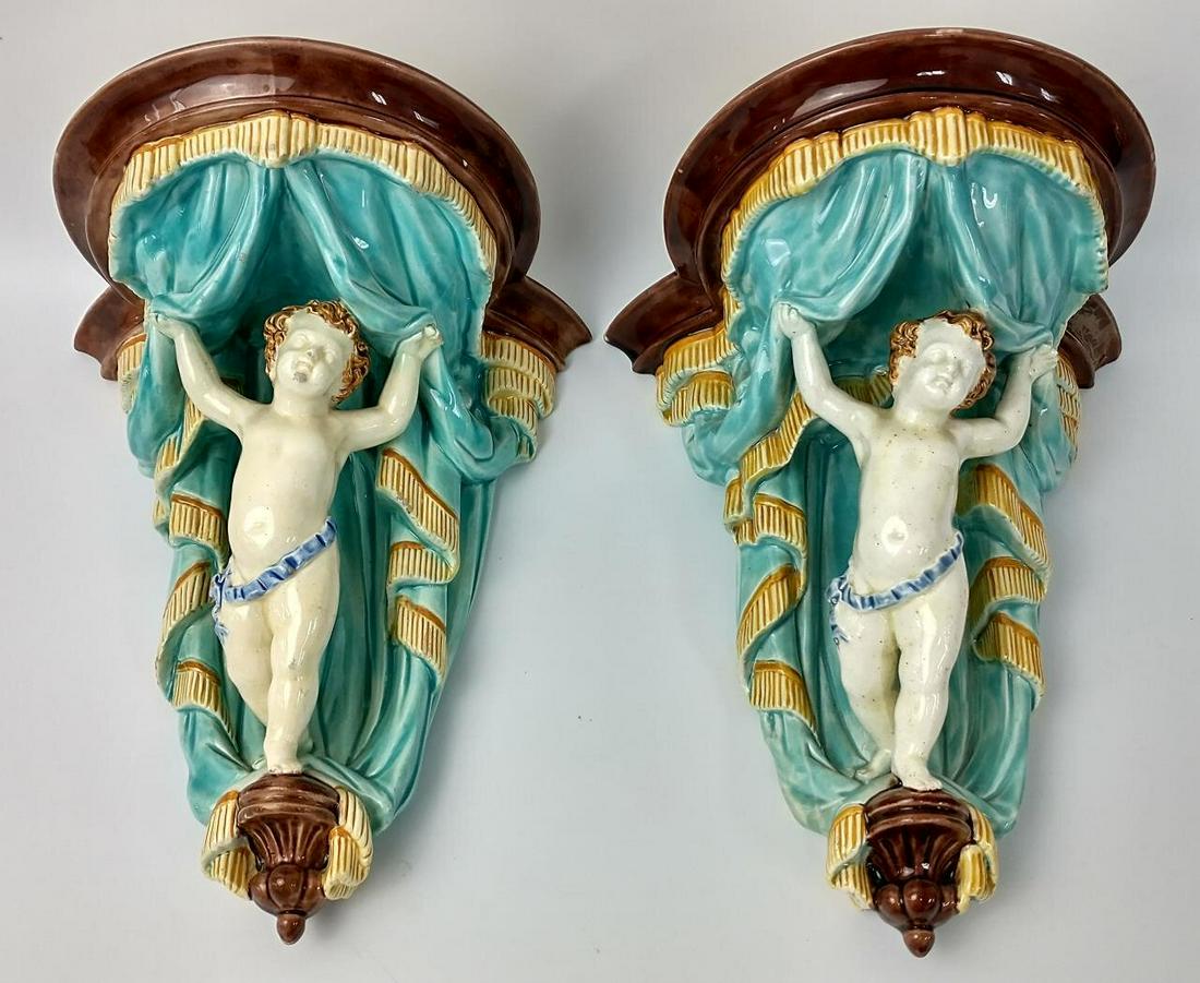 Pair of Early Wedgewood Majolica Wall Brackets.: Pair of Early Wedgewood Majolica Wall Brackets, Depicting Cupids. Fully Impressed with Marks. Condition: Generally Good Condition. With some very minor missing glaze and a small repair on one corner. 