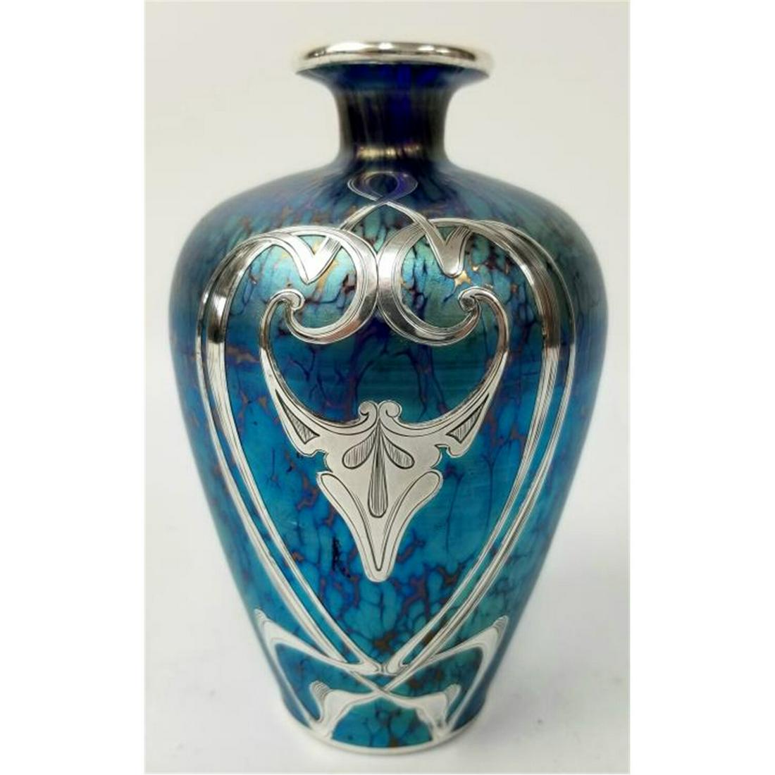 Loetz Silver Overlay Art Glass Blue Vase.: Loetz Silver Overlay Art Glass Blue Iridescent Vase with Art Nouveau Decoration & Remnants of Paper Label. Condition: Appears to be in Generally Good Condition. Dimensions: H-5". Provenance: From a Lo