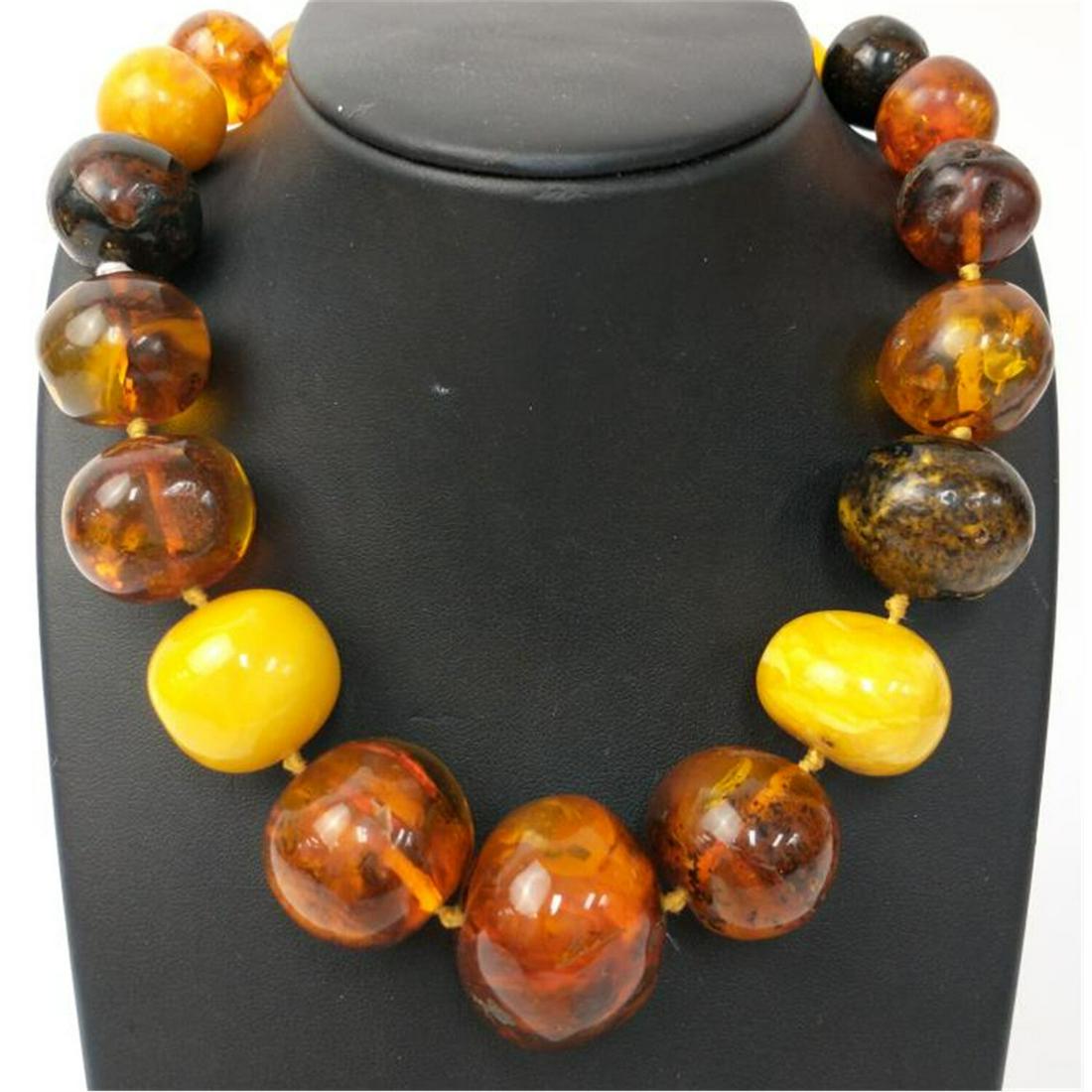 Unusual Large Amber Necklace with 9K Gold Clasp.: Unusual Large Amber Necklace with 9K Gold Clasp. Condition: Generally Good Condition. Dimensions: L- 16". Total Weight: 96.6g. Provenance: From a Long Island, NY Home. Please note the absence of a con