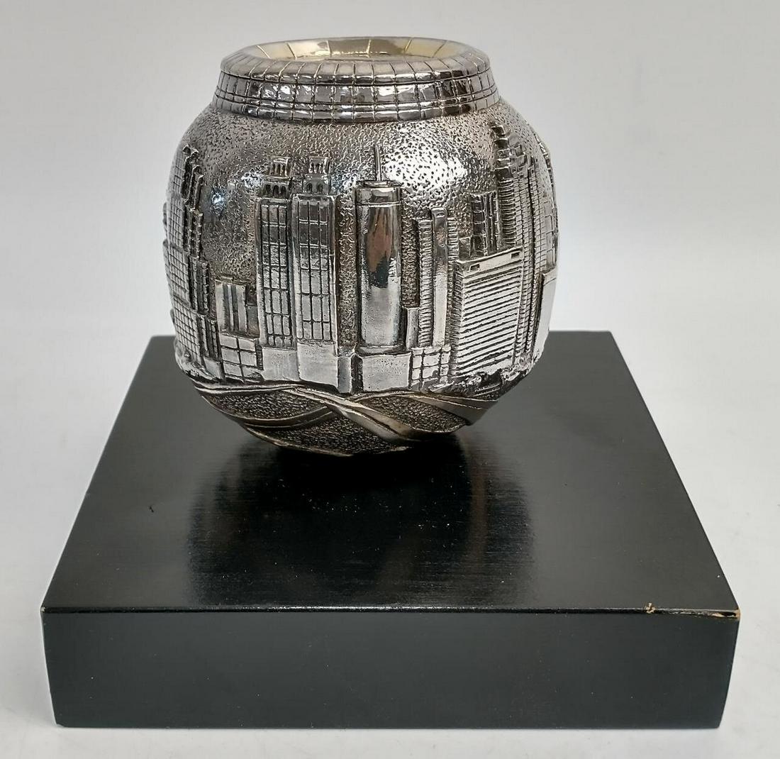 Rare Sterling Silver Clad View of NYC & Twin Towers: Rare Sterling Silver Clad View of New York City Skyline Including Twin Towers ( World Trade Center ) on Wood Base. Condition: Very Good. Dimensions: Total H-3" Excluding Base x Dia-3". Provenance: Fro