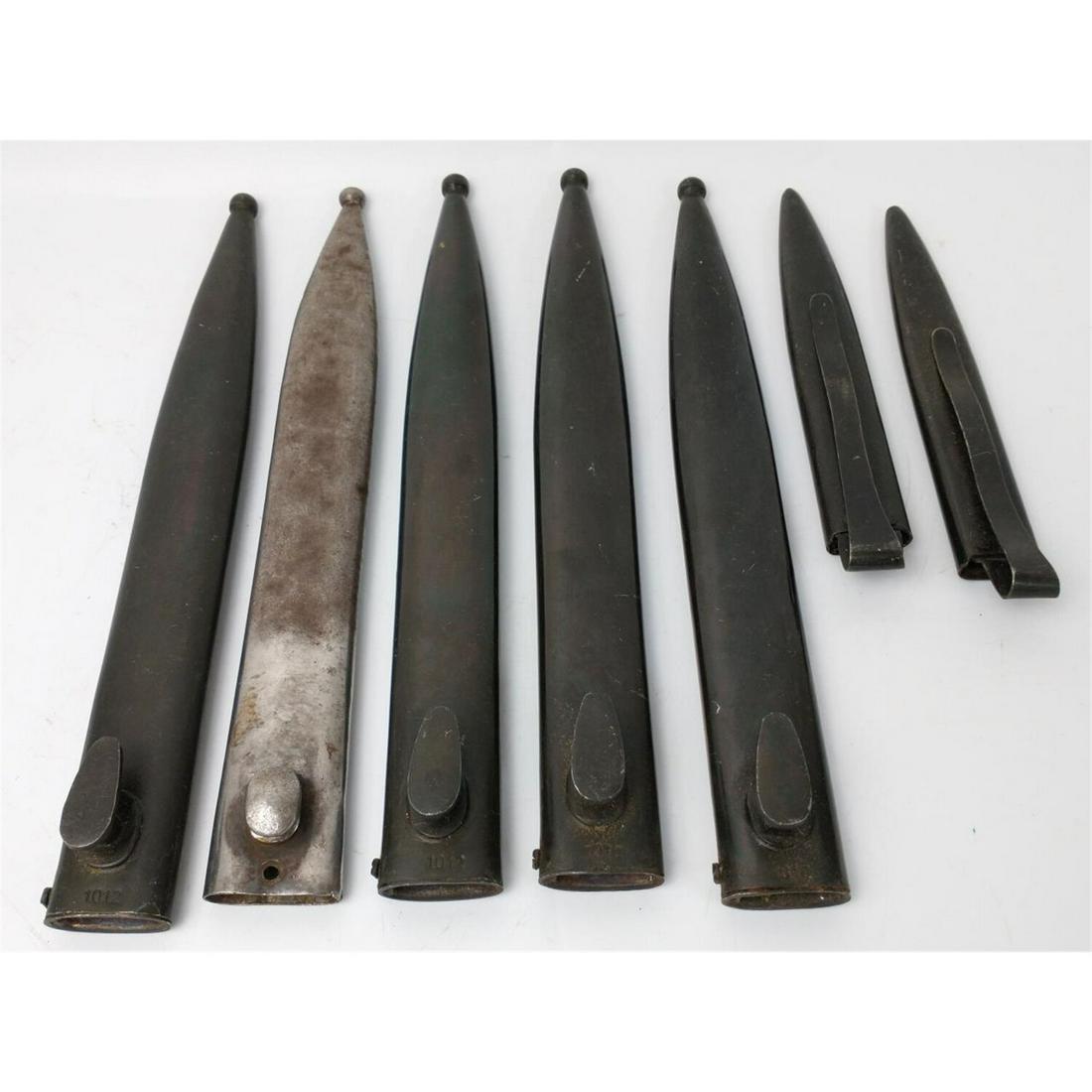 WWII Rifle Bayonet & Scabbard Lot. 7 Items Total.: WWII Rifle Bayonet & Scabbard Lot. 7 Items Total.Condition: As FoundDimensions: Largest- L-10.5"Provenance: From a New York City Estate.Please note the absence of a condition report does not imply tha