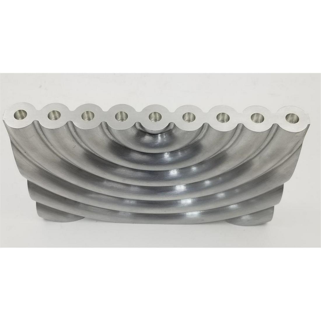Judaica Carved Aluminum Menorah by Zelig Segal: Judaica Carved One Piece Aluminum "Hanukkiah" by Zelig Segal. Fully Signed and Numbered.Condition: Excellent.Dimensions: L-8.9" H-5.9" Thickness- 1.25".Provenance: From a North Shore, Long Island, NY 