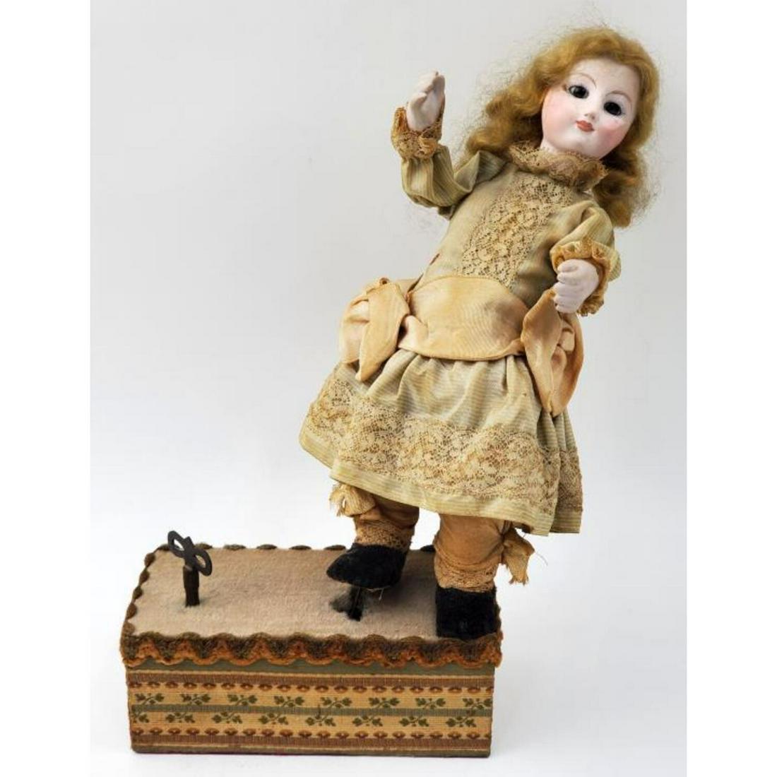 Antique Mid 19thc French Mechanical Musical Doll: Antique Mid 19thc French Mechanical Musical Doll with Porcelain Face and Hands and Glass Eyes. When it is Winded it Plays a Tune and the Body and Hands Start Moving. In Original Dress, Probably Human 