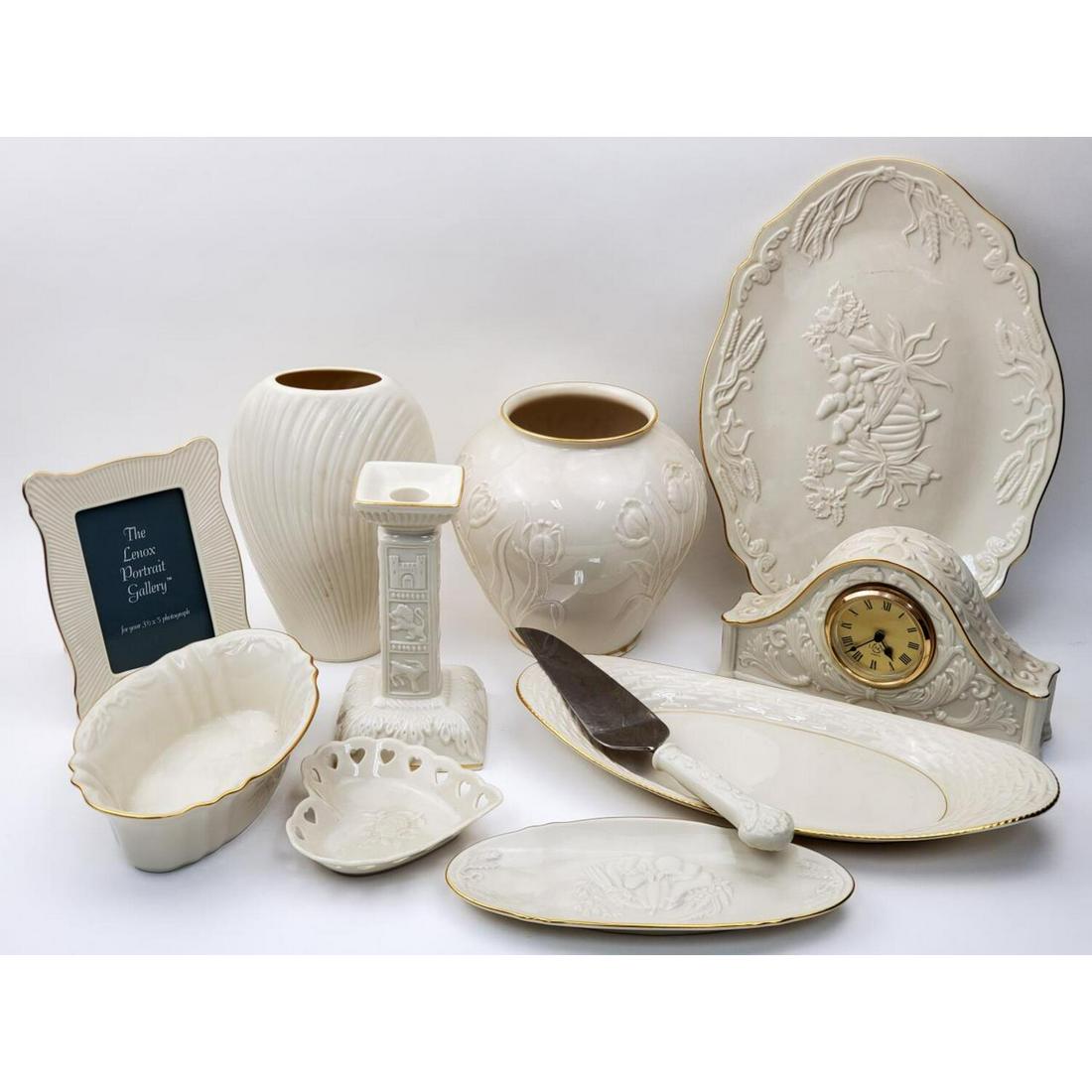 Large Lot of 11 Lenox Porcelain items: Large Lot of 11 Lenox Porcelain items including Desk Clock, Picture Frame, Candle stick, Cake cutter, Vases and Bowls.Condition: Generally very good conditionDimensions: Largest 14" x !0"Provenance: F