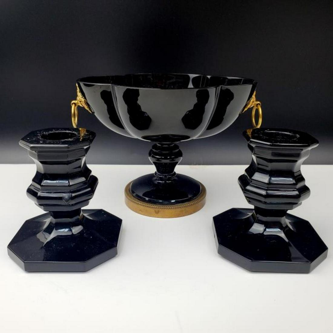 Unusual 3 Piece Baccarat Black Glass Items.: Unusual 3 Piece Baccarat Black Glass Bronze Mounted Footed Candy Dish Along w/ a Pair of Candle Sticks. All Fully Signed. Condition: Excellent.Dimensions: Dish- L-6" x W-4.25" x H-4.25".Provenance: Fr