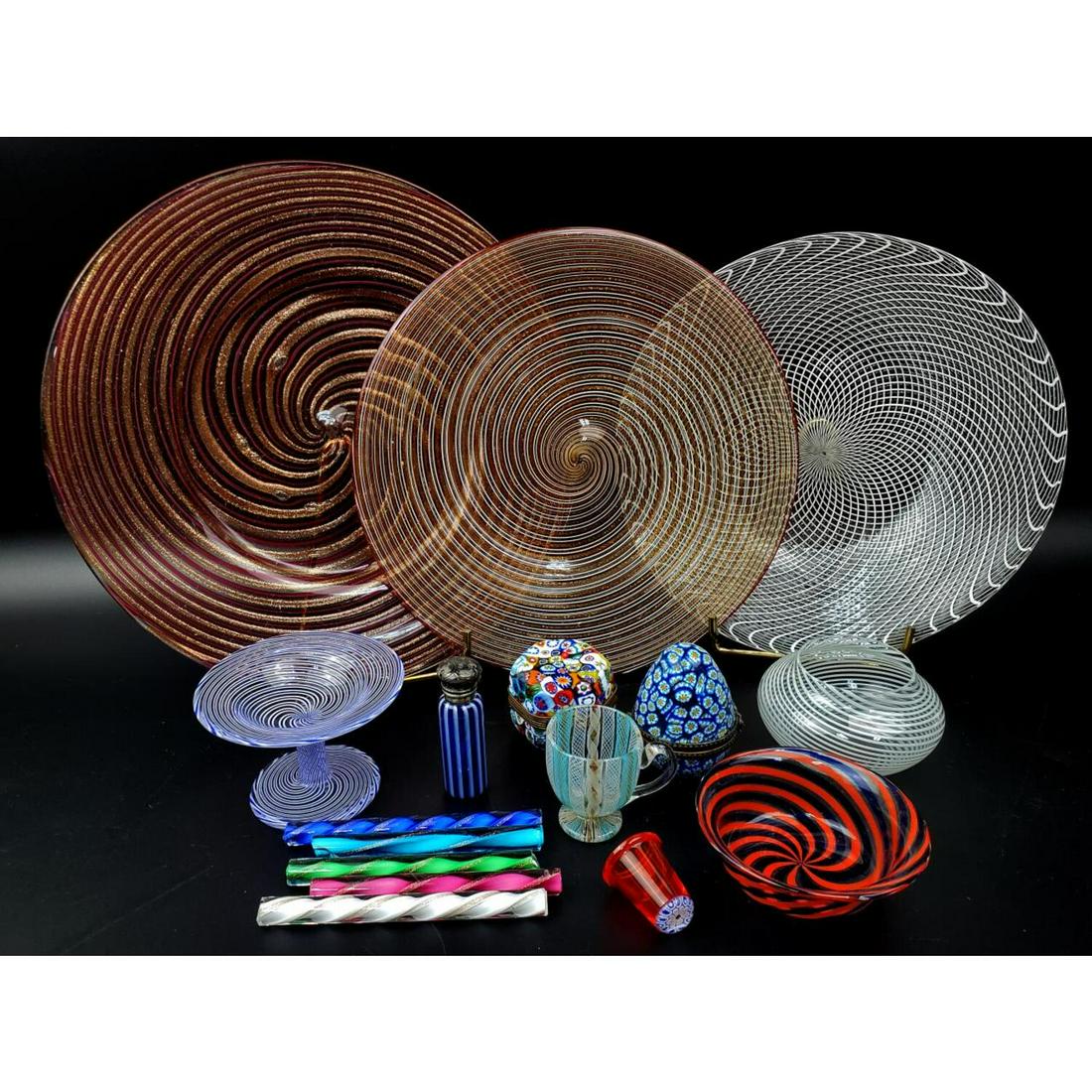 Large Lot of Vintage Murano Italian Venetian Glass: Large Lot of Vintage Murano Italian Venetian Glass Items Including 2 Milliefiori Small Boxes, 1 Small Scent Bottle, 3 Plates, Vases, Cup, Thimble, ect. Altogether 16 Pieces. Condition: Excellent. Dime