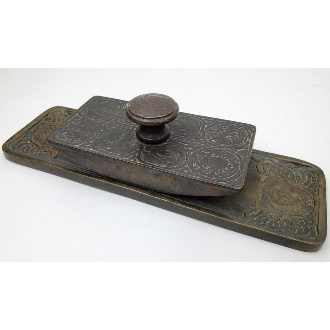 2 Tiffany Studios Bronze Zodiac Pattern Items: 2 Tiffany Studios Bronze Zodiac Pattern Items Including Penholder and a Blotter. Fully Marked and Numbered 990 and 1000. Condition: Generally Very Good. Used. Dimension: Penholder L- 9.8", W- 3.2". Pr