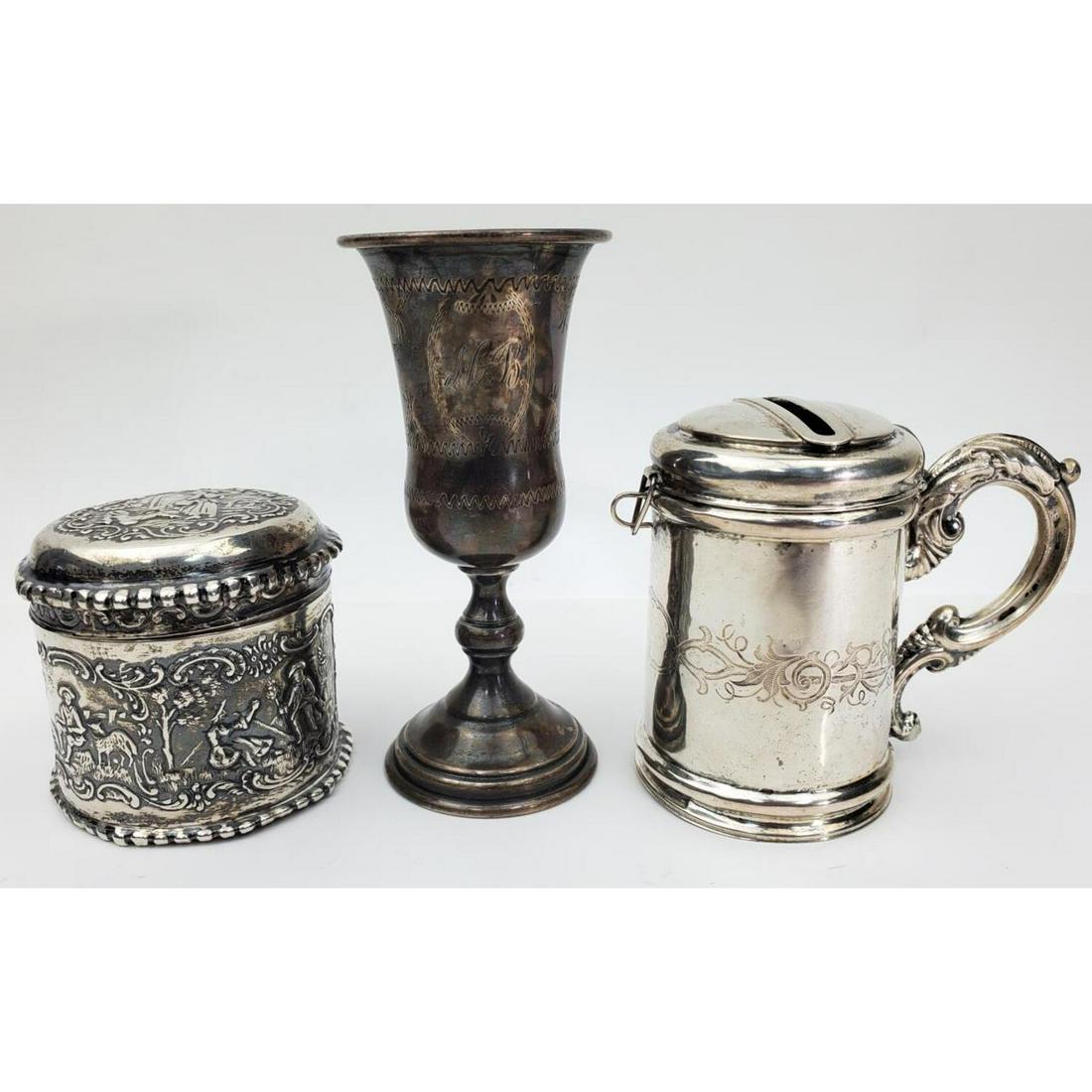 3 Sterling Silver Judaica Items: 3 Sterling Silver Judaica Items including 1 Kiddish Cup, 1 Besamim Spice Box and 1 Tzedakah Box. All Fully Hallmarked. Kiddish Cup is Monogrammed.Condition: Generally Good. Hinge Broken on the Lid of 
