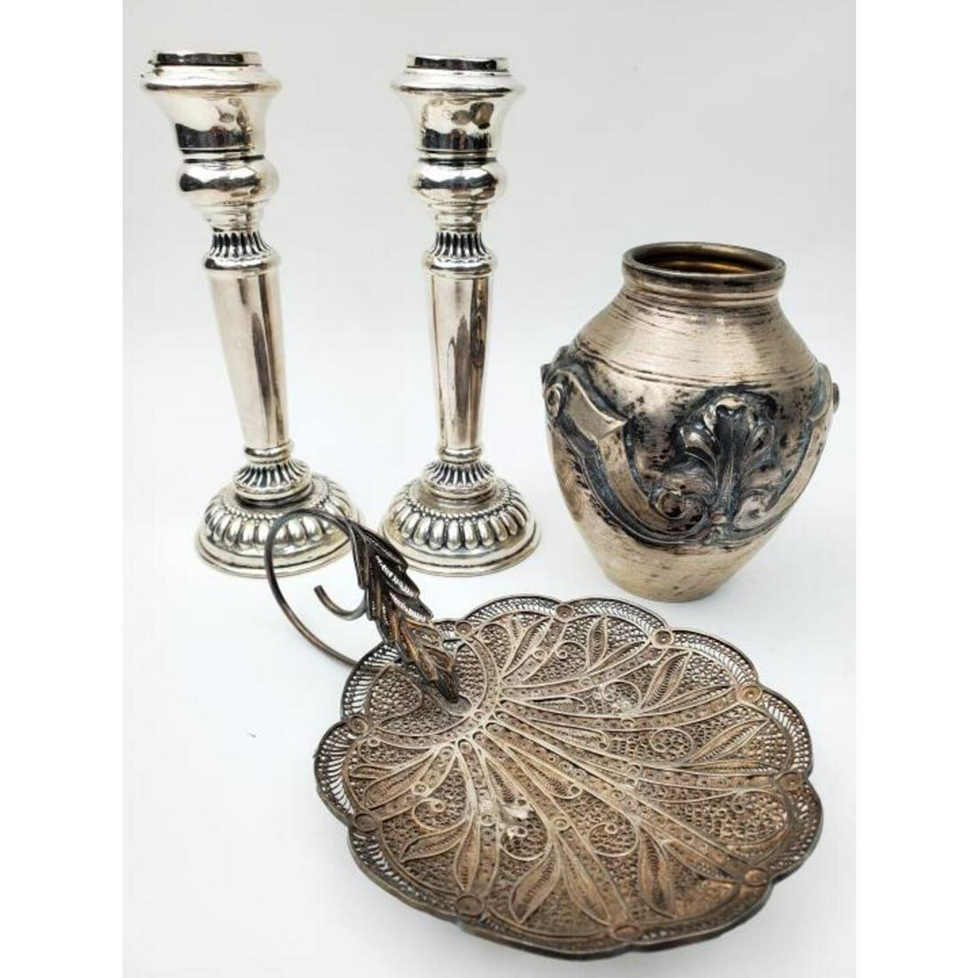 4 Piece Lot of Silver Items: 4 Piece Lot of Silver Items including a Heavy Filigree Small Handled Dish, a Small Vase and 2 Small Candlesticks. Candlesticks are Partially Weighted.Condition: 1 Candlestick has small damage.Dimensio