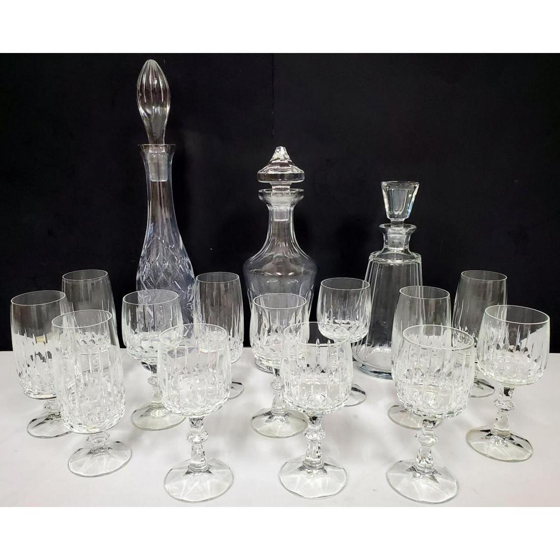 Large Lot of Vintage Cut Glass Items: Large Lot of Vintage Cut Glass Items Including 3 Covered Decanters, 6 Champagne Glasses, and 7 Wine Glasses. Condition: All Generally Good. Dimensions: Tallest Decanter- 17". Provenance: From a New Je