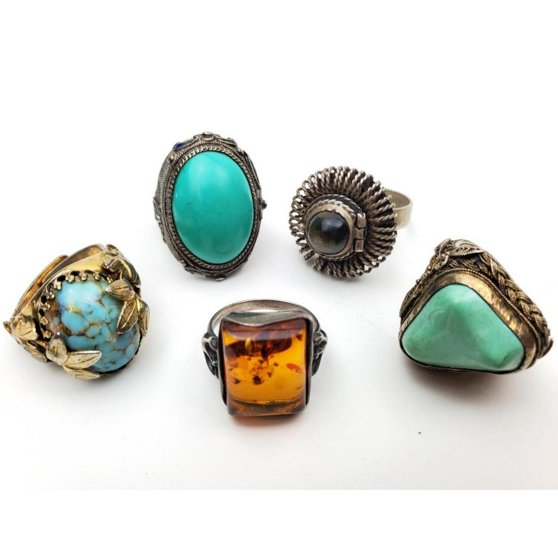 Lot of 5 Antique Sterling Silver Rings: Lot of 5 Antique Sterling Silver Rings Including an Poison Ring with Tiger Eye, 1 Amber, and 3 Others. Condition: Generally Good. Dimensions: Enameled Pin Dia- 1.5". Total Weight: 36.8 g. Provenance: 