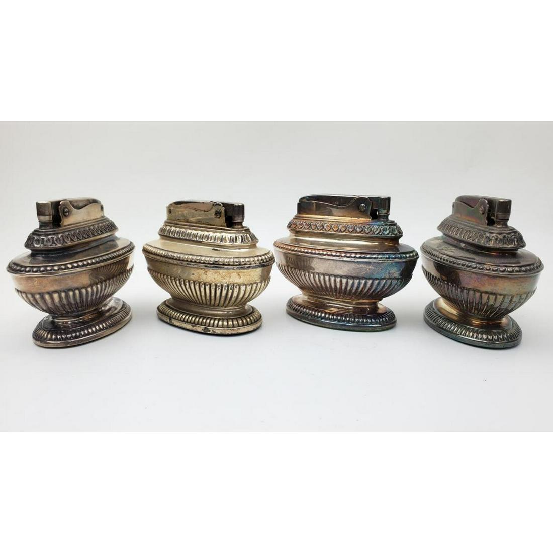 4 Vintage Ronson "Queen Anne" Table Lighters: Lot of 4 Vintage Ronson "Queen Anne" Table Lighters.Condition: Generally Good. Tarnished.Dimensions: Length 3.2". Height 2.5".Provenance: From a Long Island, NY Home.Please note the absence of a condi