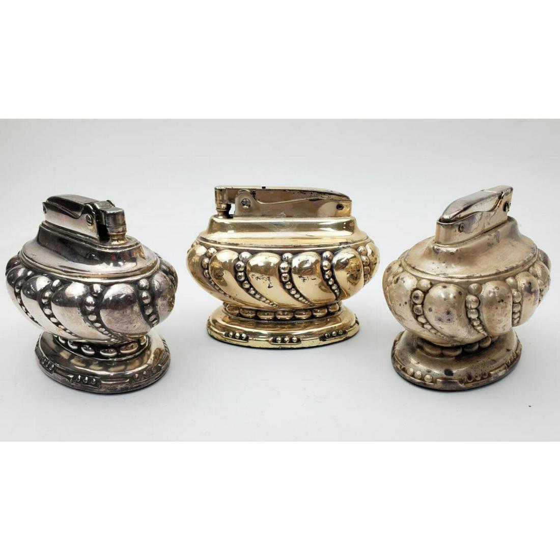 Lot of 3 Vintage Ronson "Crown" Table Lighters: Lot of 3 Vintage Ronson "Crown" Table Lighters.Condition: Generally Good. Tarnished.Dimensions: Length 3". Height 2.25".Provenance: From a Long Island, NY Home.Please note the absence of a condition r