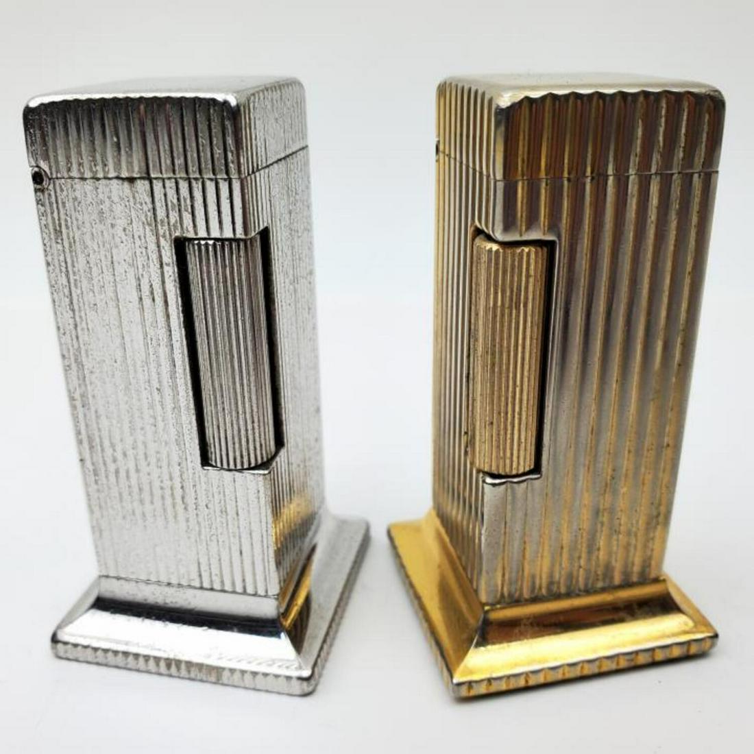 2 Vintage Dunhill Rollalite Fluted Table Lighters: 2 Vintage Dunhill Rollalite Fluted Table Lighters. Condition: Generally Good. As Is. Dimensions: Provenance: From a Long Island, NY Home. Please note the absence of a condition report does not imply t