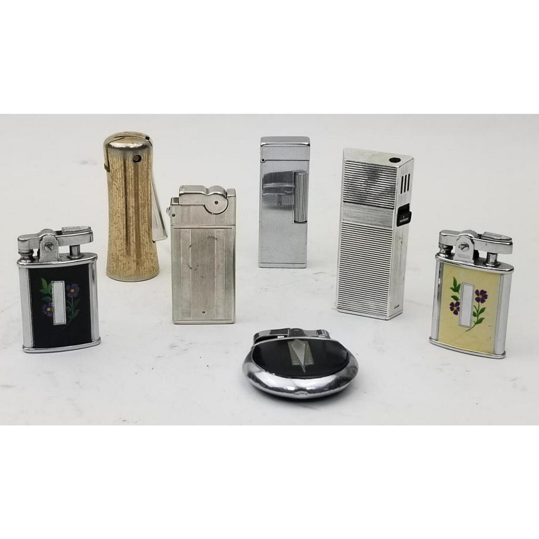 Lot of 7 Cigarette Lighters: Lot of 7 Cigarette Lighters Including Ronson, ASR, and Another. Condition: Generally Good. As Is. Dimensions: Largest 3" x 1.25". Provenance: From an Estate of a Collector in Long Island, NY. Please n