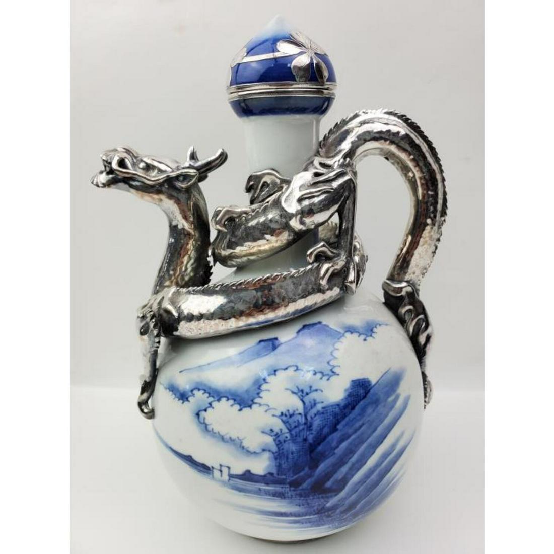 Japanese Silver Overlaid Blue/White Porcelain: Japanese Meiji Period Silver Overlaid Blue and Porcelain Ewer with Dragon Motif. Condition: Excellent. Dimensions: H- 10", Handle to Spout- 7". Provenance: Private Collection of the Estate of a Long T