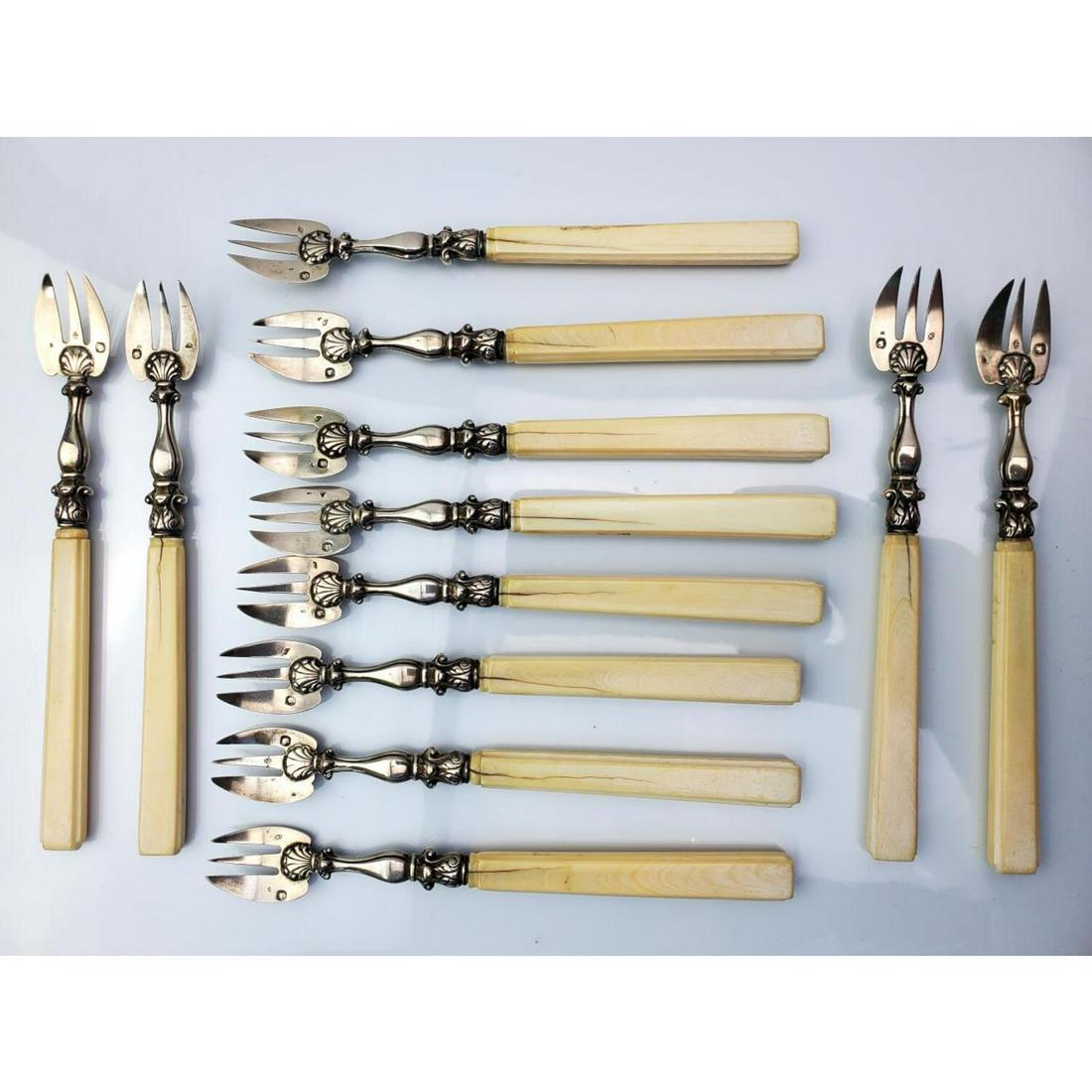 12 French Sterling Silver Seafood Forks Circa 1858: Set of 12 French Sterling Silver Seafood Forks Circa 1858 by Benoit and Lanos, Paris, France. With Carved Bone Handles.Condition: Generally Good.Weight:Size: Length of Each 5.75".Provenance: From a Pr