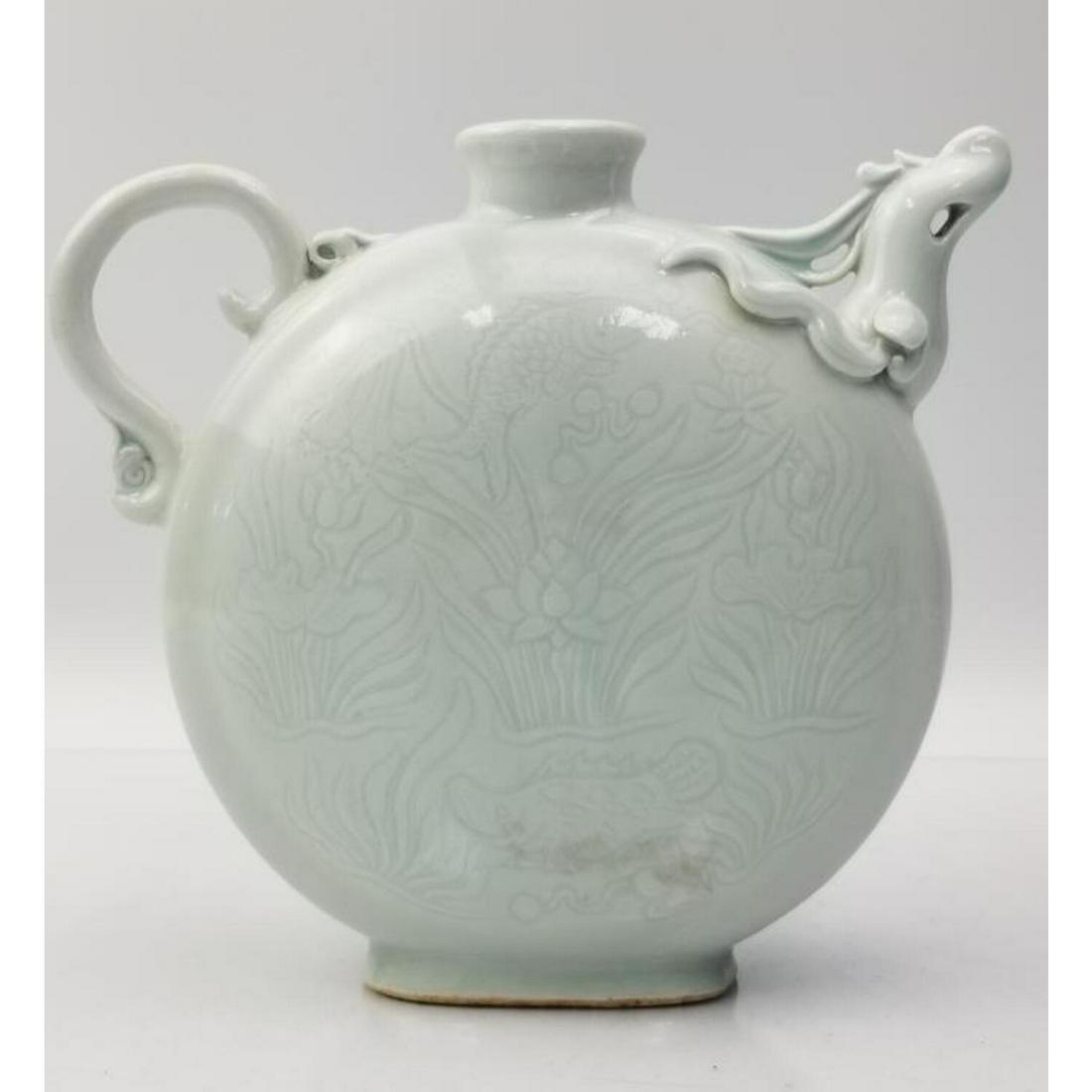 Chinese Monochrome Light Gray Phoenix Form Moon Porcelain Pitcher: Chinese Monochrome Light Gray Phoenix Form Moon Porcelain Pitcher with Dragon Motif. Condition: Excellent. Dimensions: Handle to Spout- 8", H- 7". Provenance: From a Long Island, NY Home. Please note 