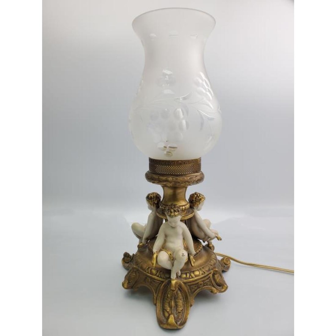 Vintage Figural Metal Lamp Base / Glass Shade: Vintage Figural Metal Lamp Base with Cut Glass Shade.Condition: Generally Good. Some minor losses to the paint. Dimensions: H- 14" Provenance: From a Long Island, NY HomePlease note the absence of a C