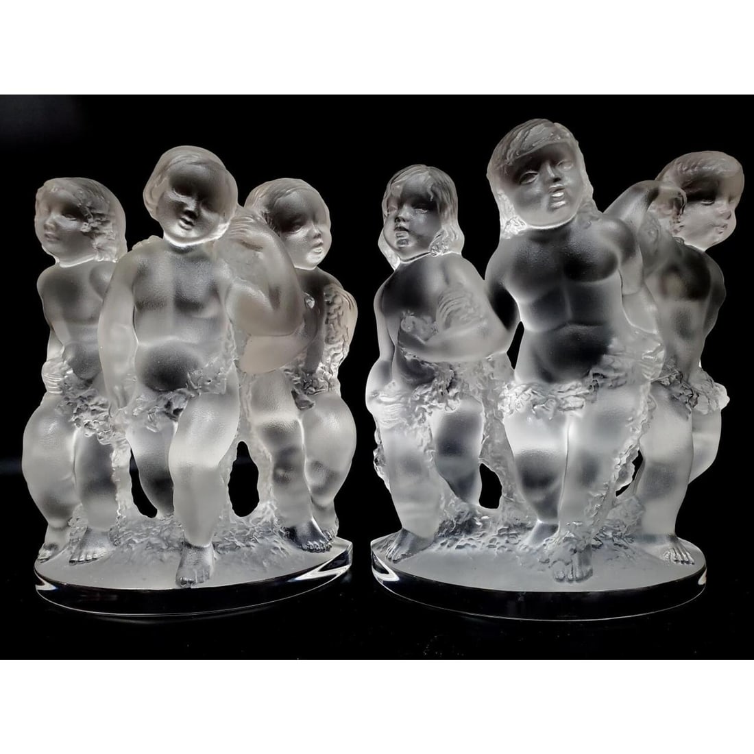 Pair of Lalique "Luxembourg" Cherub Bookends: Pair of Lalique "Luxembourg" Cherub Bookends. Condition: Excellent. Dimensions: H- 7.75" x W- 7.25". Provenance: From a Long Island, NY Home. Please note the absence of a Condition Report does not imp