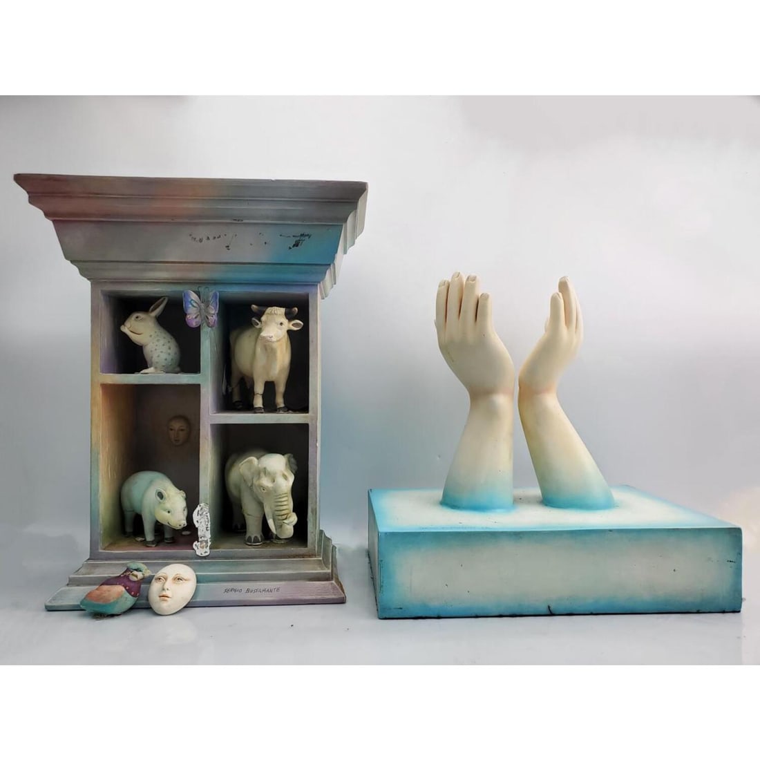 Lot of 2 Limited Edition Sergio Bustamante Art: Lot of 2 Limited Edition Sergio Bustamante Art. Condition: Both Have Losses & Repairs. Sold As Is. Dimensions: Hand Sculpture- L- 14" x H- 14" x W- 9". Shelf- H- 16.5". Provenance: From a New York Cit