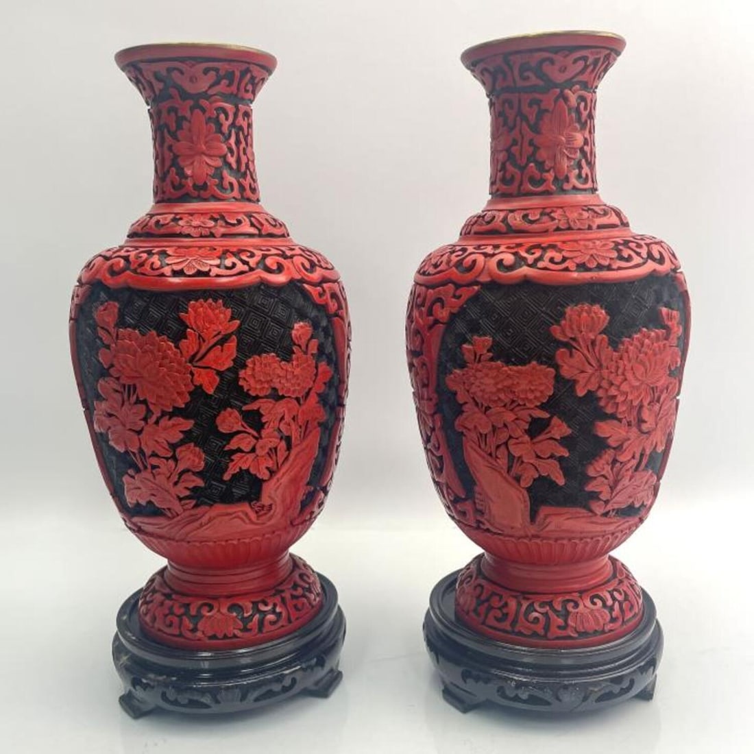 Pair of Chinese Carved Cinnabar Vases: Pair of Chinese Carved Cinnabar Vases with Wooden Bases. Condition: Generally Very Good. Dimensions: Vase H- 10', Total H w/ Bases- 11.25". Provenance: From a Long Island, NY Private Collector. Please