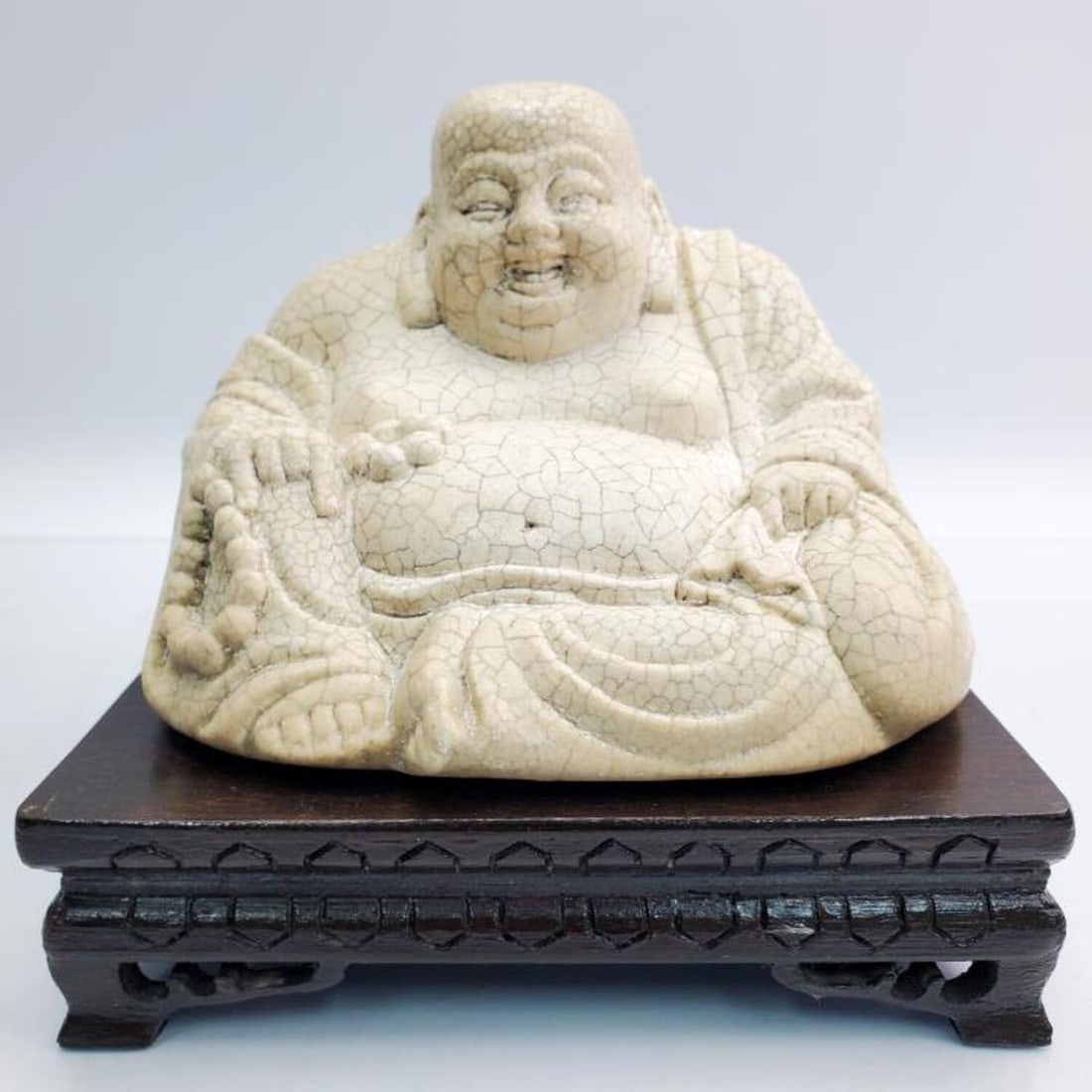 Chinese Carved Stone Figure of Seated Buddha: Chinese Carved Stone Figure of Seated Buddha on Original Carved Wood Base. Condition: Excellent. Dimensions: Buddha L- 6.3" x W- 5.6" H- 4.75". Base- 6.8" x 5.8" x 1.7". Provenance: From an Estate of 