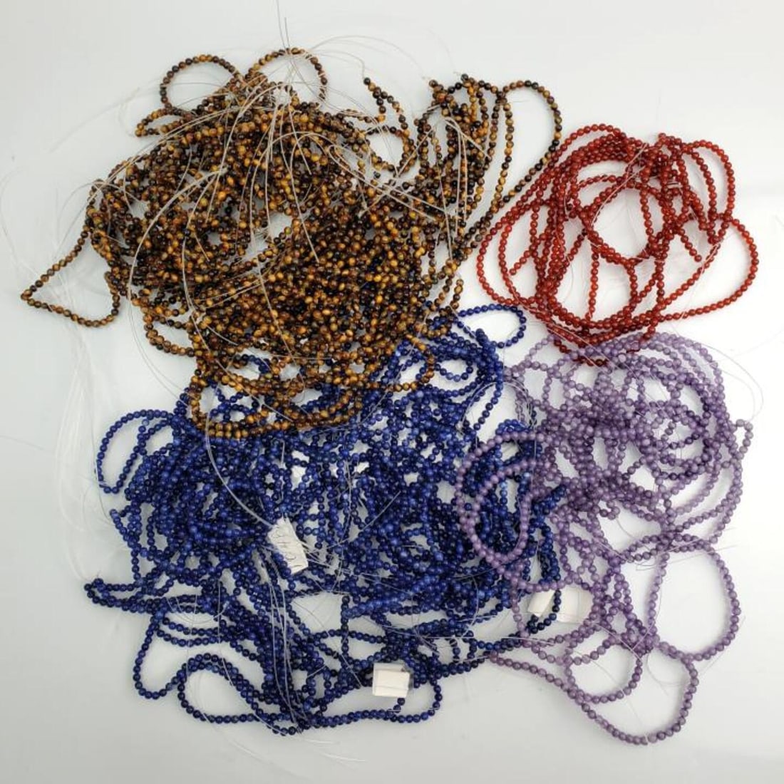 Large Lot of Various Semi Precious Beads: Large Lot of Various Semi Precious Beads Including Tiger Eye, Carnelian, Amethyst & Sodalite. Many of Them are On Necklaces or Bracelets. Condition: Generally Good, As Found. Dimensions: Varies. Prove