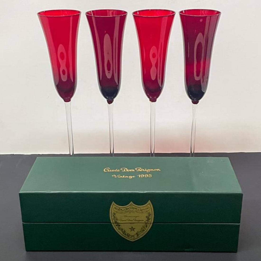 Vintage 1995 Dom Perignon Champagne & 4 Flutes: Vintage 1995 Dom Perignon Champagne in Sealed, Unopened Box Along with 4 Red Bohemia Champagne Flutes. Condition: Excellent, Sealed in Box. Some Small Scuffs to the Box. Dimensions: Box- 12.4" x 4.25"