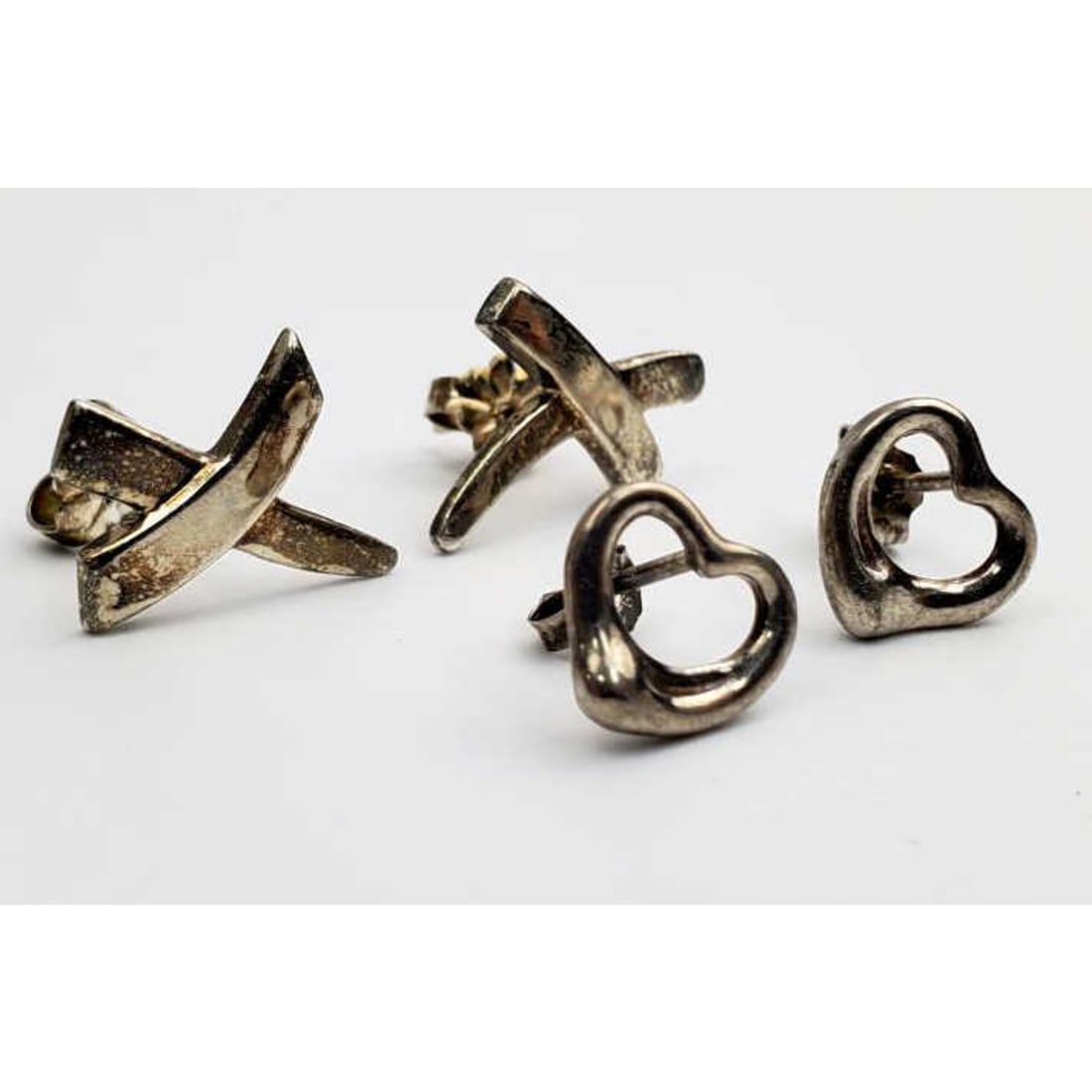 2 Pairs of Tiffany & Co Sterling Silver Earrings: 2 Pairs of Tiffany & Co Sterling Silver Earrings Including Paloma Picasso & Elsa Perreti. Condition: Generally Good w/ Tarnish. Dimensions: Larger-0.75" x 0.5". Total Weight: 4.2g/0.14ozt. Provenance: