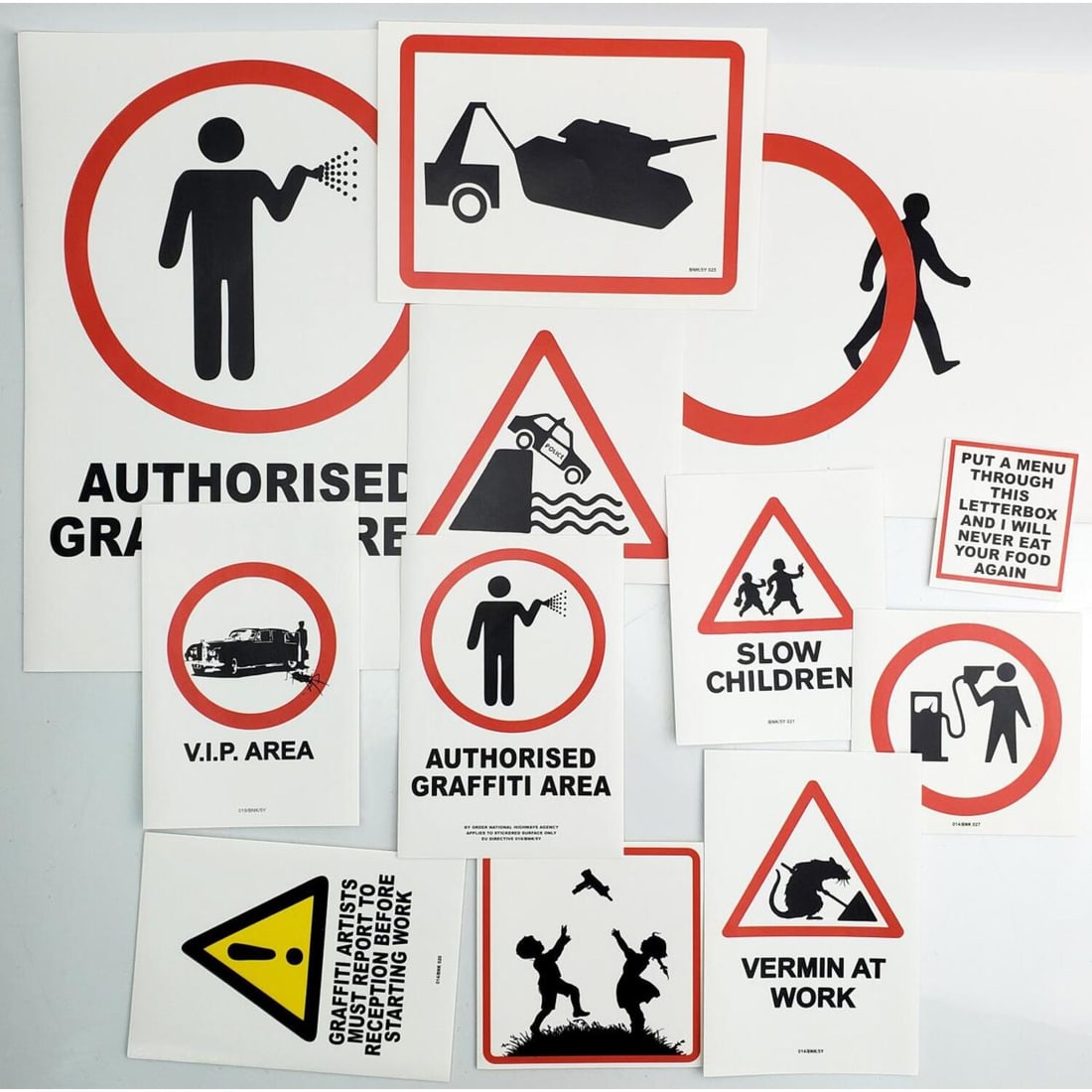 After Banksy Lot of 12 Stickers; "Petrol Head": After & Attributed to Banksy, British Lot of 12 Stickers Designed by Banksy Including "Petrol Head", "Towing Tank" & "Graffiti Artists Must Report to Reception" & Others. We Do Not Guarantee the Authe