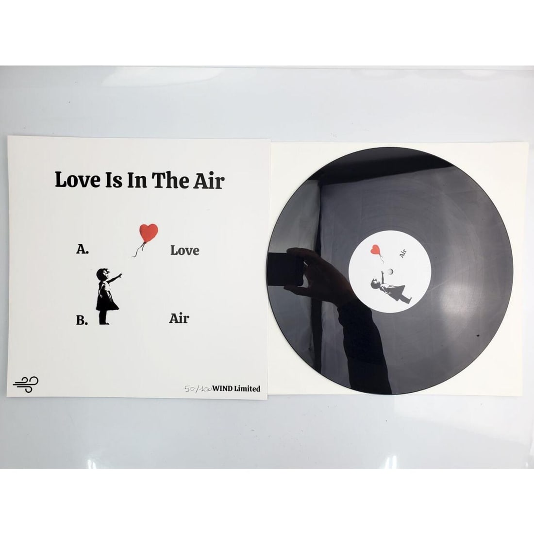 After Banksy Vinyl EP Record "Love Is In The Air": After & Attributed to Banksy, Vinyl EP Record "Love Is In The Air". In Original Cover & Plastic. Numbered 50/100 Wind Limited. We Do Not Guarantee the Authenticity of This Item. Condition: Excellent. 