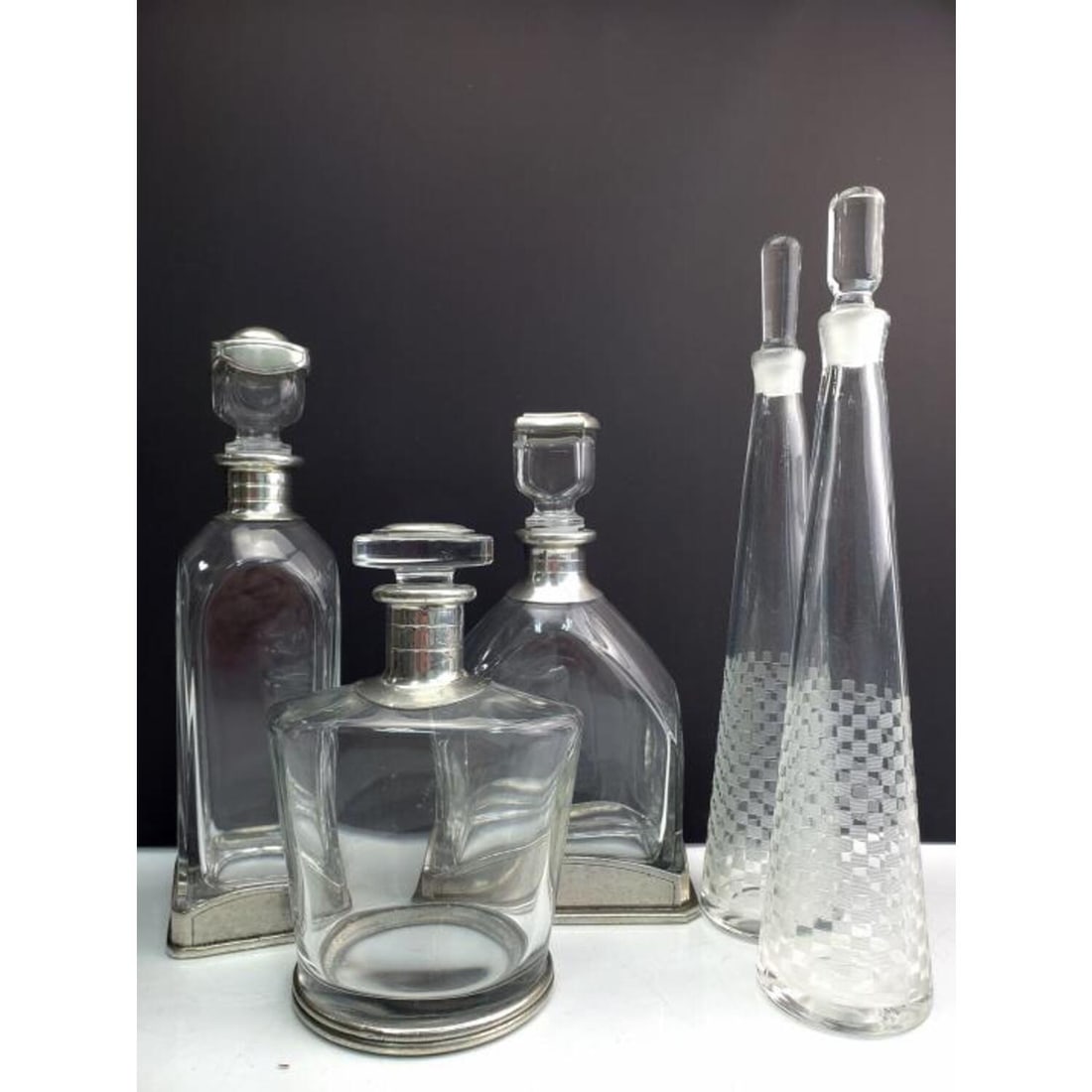 Lot of 5 Glass Decanters Incl. 3 w/ Pewter Mounts: Lot of 5 Glass Decanters Including 3 with Pewter Mounts and 2 with Engravings. Pewter are Fully Hallmarked. Condition: Generally Very Good. Dimensions: Tallest H- 14" x Widest W- 6". Provenance: From 