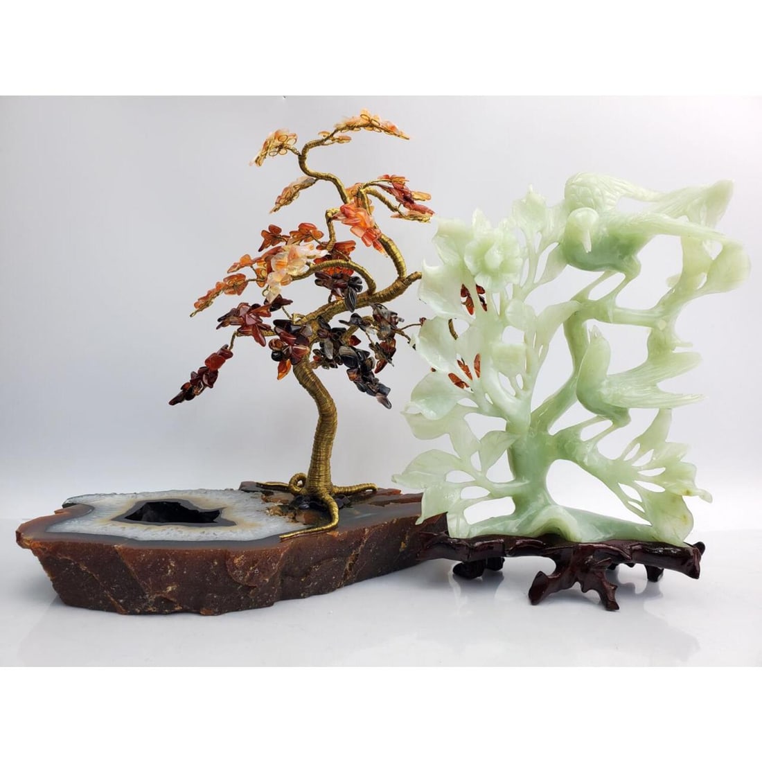 Lot of 2 Chinese Sculptures Including One Jadeite: Lot of 2 Chinese Sculptures Including One Jadeite Depicting Birds on Original Wood Base and One Agate Leaved Tree. Condition: Both Generally Very Good. Dimensions: Larger (Tree) H- 11" x L- 11" x Dept
